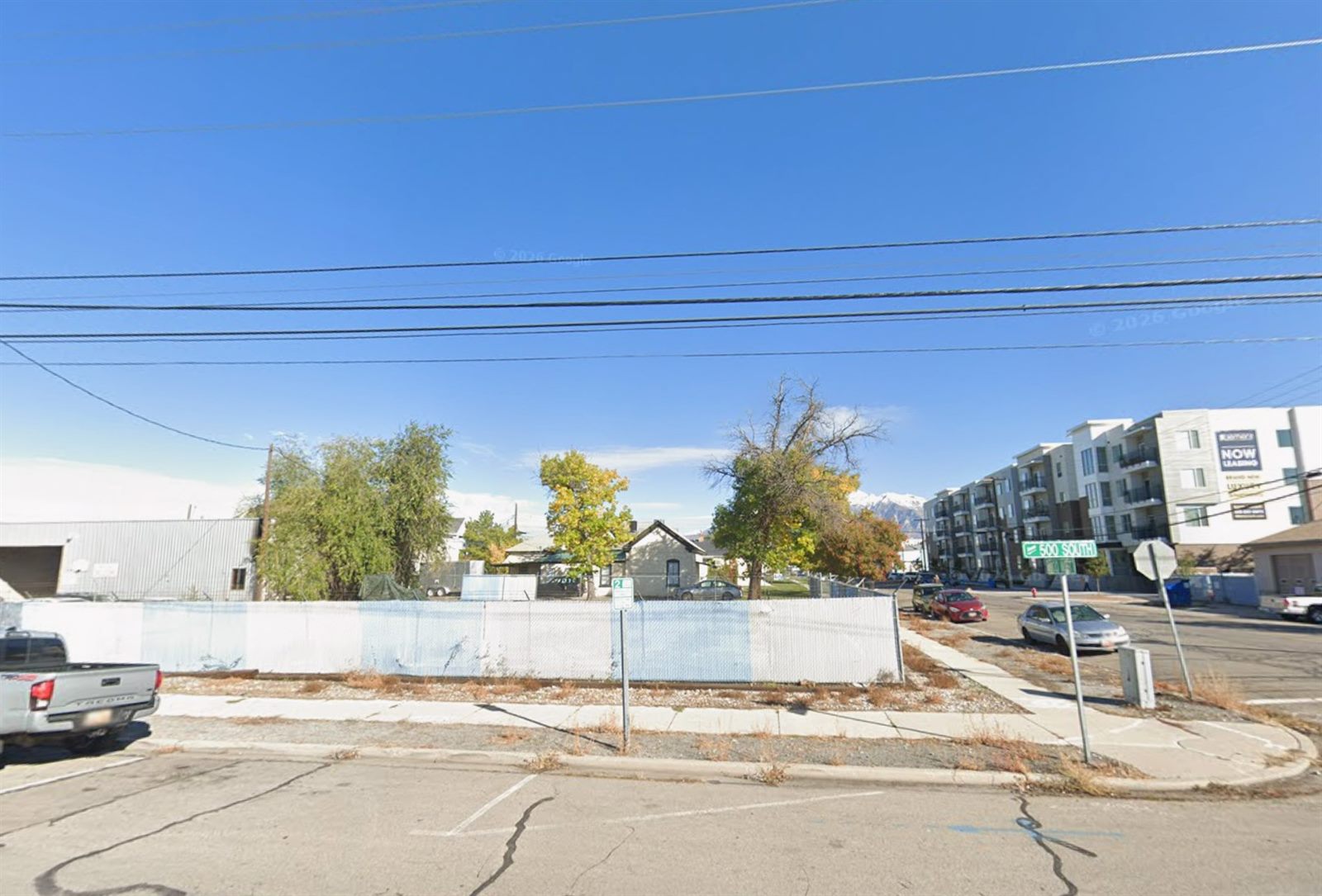 A vacant, fenced-off corner lot in Provo
